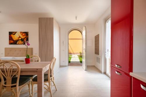 a kitchen and dining room with a wooden table and chairs at Sul Calar del Sole al Conero in Recanati