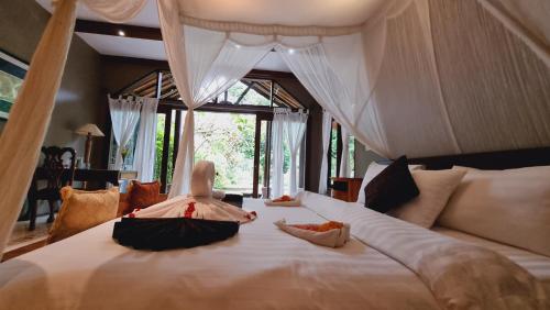 a little girl laying on a bed in a room at Avalon Ubud Castle & SPA in Ubud