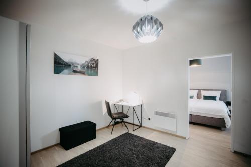 a bedroom with a bed and a desk with a chair at St. Antoni Suite 7 in Eisenstadt