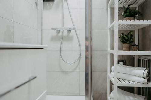 a shower with a hose in a bathroom at St. Antoni Suite 7 in Eisenstadt