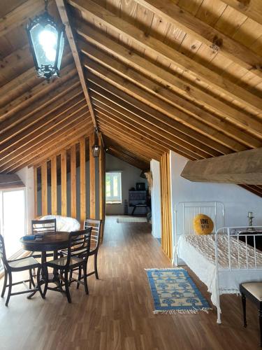 a bedroom with a bed and a table and chairs at Green Sunrise House in Nordeste