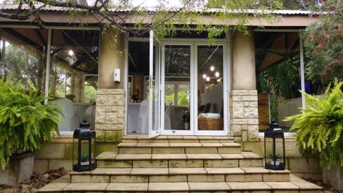 a front porch of a house with glass doors at North Haven Country Estate in Honeydew