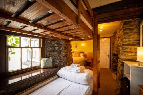 a room with two beds and a window at The Sun Boutique and Lounge in Hawkshead