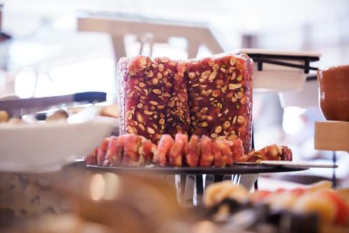 a cake with nuts on it sitting on a table at Pavlo Napa Beach Hotel in Ayia Napa