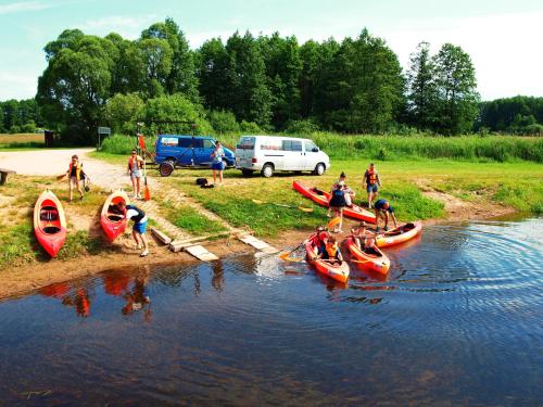 a group of people in kayaks on a river at Biebrza24 - Agroturystyka in Sztabin