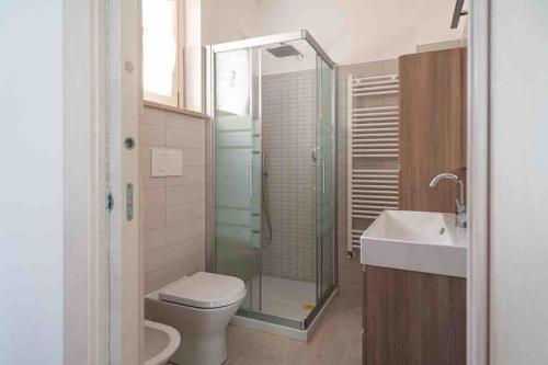 a bathroom with a shower and a toilet and a sink at Sul Calar del Sole al Conero in Recanati