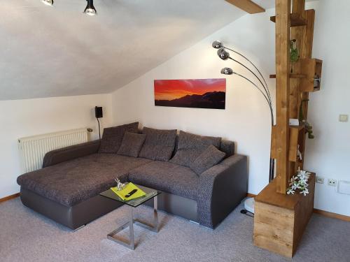 a living room with a couch and a table at Alpenflair in Wertach