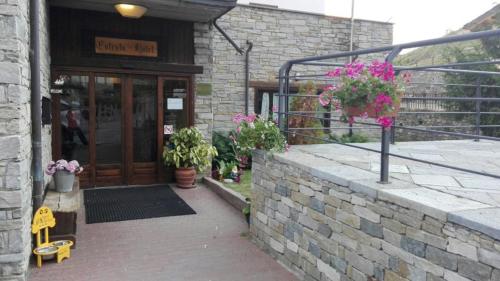 a entrance to a building with potted plants on it at Hotel & Restaurant Saint Nicolas Gran Paradiso in Saint Nicolas