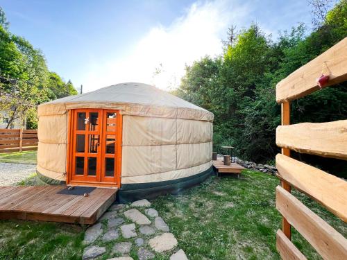 a yurt with a wooden deck in a yard at Pataklak Mátra in Matrakeresztes