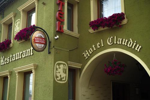 a building with a sign on the front of it at Hotel Claudiu in Sighişoara