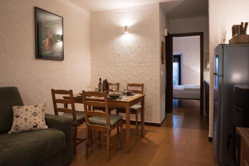 a living room with a dining room table and a couch at bb26 apartment mountain Lozio in Lozio