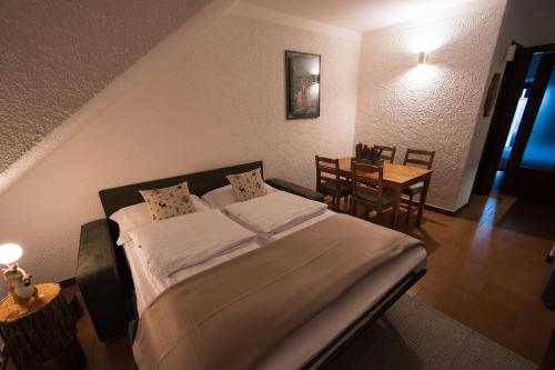 a hotel room with a bed and a table at bb26 apartment mountain Lozio in Lozio
