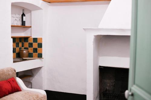 a living room with a fireplace and a couch at La Cachette du Comte in Montfort-sur-Argens