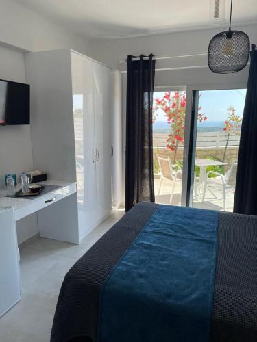 a bedroom with a bed and a view of the ocean at Villa Aspria in Rethymno