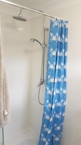 a shower curtain with sheep on it in a bathroom at Anchor cottage in Flamborough