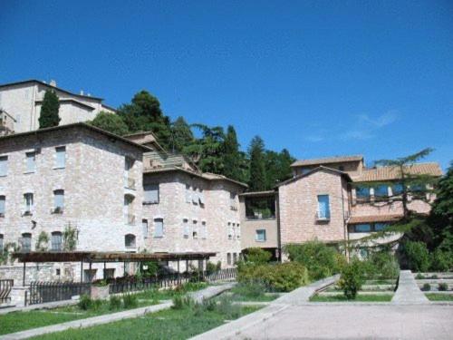a group of buildings with trees in the background at Cittadella Ospitalit&agrave; in Assisi