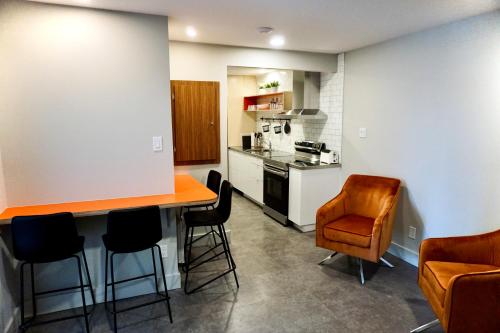 a kitchen with a table and chairs in it at Morel Executive Suites in Edmundston