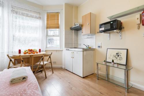 a small kitchen with a table and a dining room at Studio Appartment 1 in The Hyde