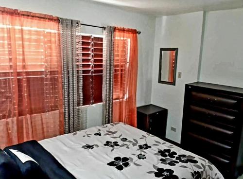 Ένα ή περισσότερα κρεβάτια σε δωμάτιο στο The Mango Lodge