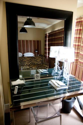a desk with a mirror in a hotel room at Milsoms Kesgrave Hall in Ipswich