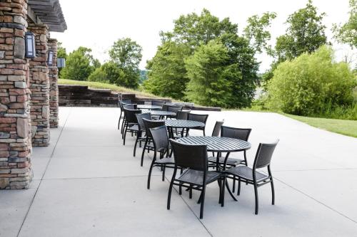 a row of tables and chairs on a patio at Holiday Inn Express & Suites Lexington North West-The Vineyard by IHG in Lexington