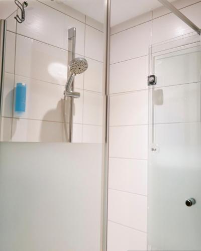 a shower in a bathroom with a glass door at Land-gut-Hotel Forellenhof in Bundenbach