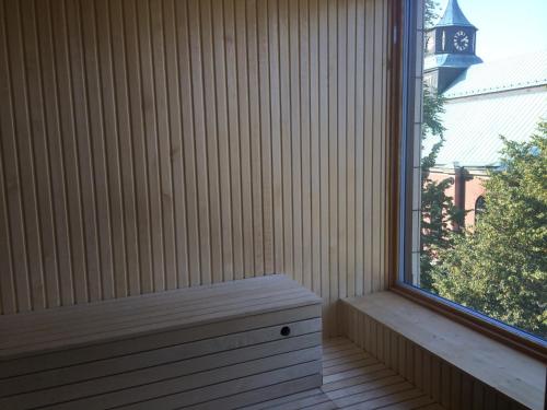 a bench sitting on a porch next to a window at Best Western Hotel Norrkoping City in Norrköping