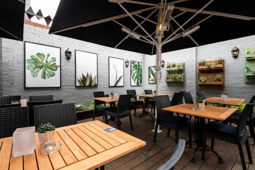 a dining room with wooden tables and chairs at The Mitre by Innkeeper's Collection in London