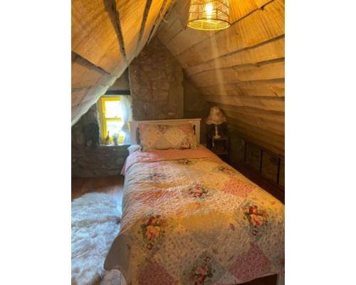 a bedroom with a bed in a attic at Slieve Gullion Getaways in Meigh