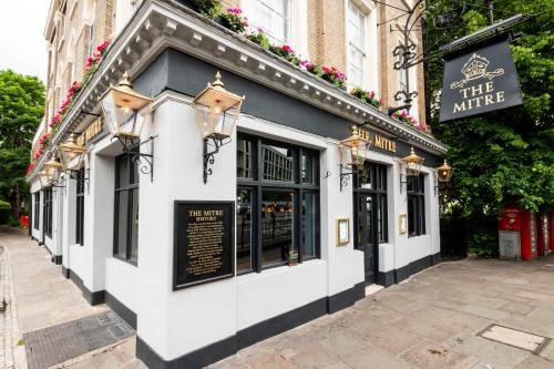 a white and black building with a sign on it at The Mitre by Innkeeper's Collection in London