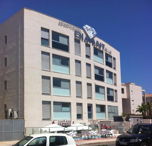 a large building with a shark on top of it at Aparthotel Diamant Blue in Playas de Orihuela