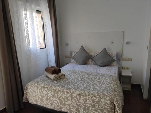 a teddy bear sitting on a bed in a bedroom at Dormir en Cádiz in Cádiz