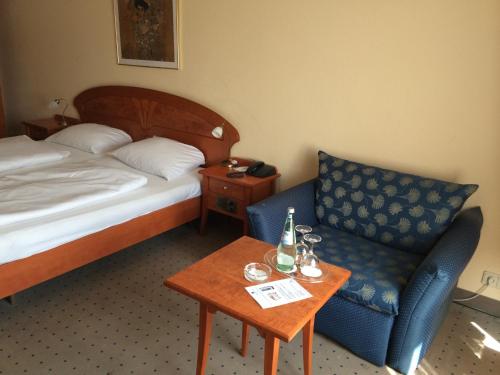 a hotel room with a bed and a chair and a table at Tryp by Wyndham Kassel City Centre in Kassel