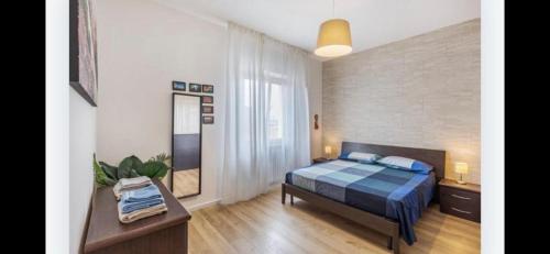 a bedroom with a bed and a mirror in it at Queen East Verona apartments in Verona