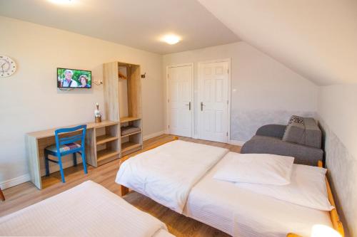 a small bedroom with a bed and a desk at HELENOWO in Lutowiska