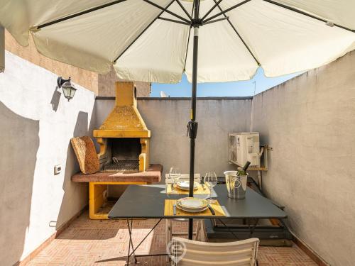 a table with an umbrella on a patio at Maty's House - Dreaming Holiday in Gonnesa