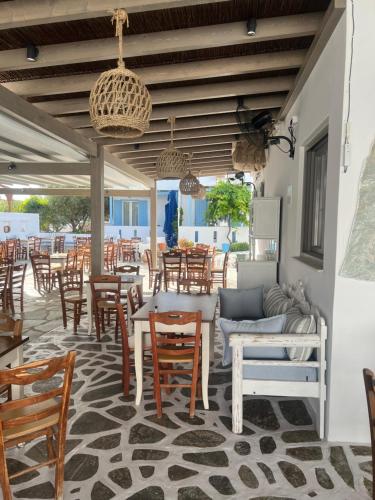 un patio con mesas, sillas, mesa y sillas en Argo, en Antíparos
