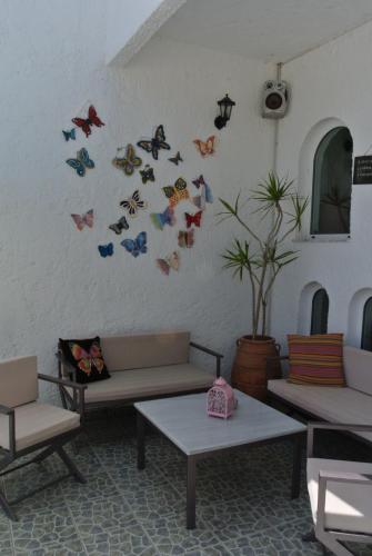 a room with tables and butterflies on the wall at Kokalakis Hotel in Kefalos