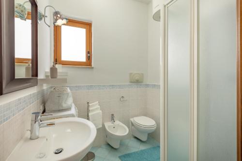 a bathroom with a sink and a toilet at Holiday Home La Notte Stellata in San Vito lo Capo