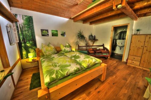 a bedroom with a bed in a room with wooden floors at Am Rübenkeller in Binzenbach