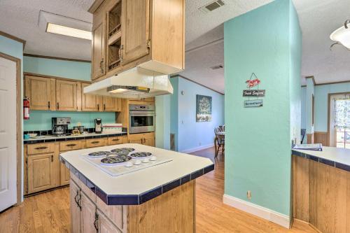 a kitchen with wooden cabinets and a stove top oven at Steinhatchee Home with Boat Parking 1 Mi to Marina in Steinhatchee