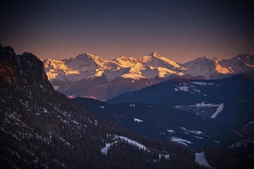a view of a mountain range with snow covered mountains at Hotel Miramonti Corvara in Corvara in Badia