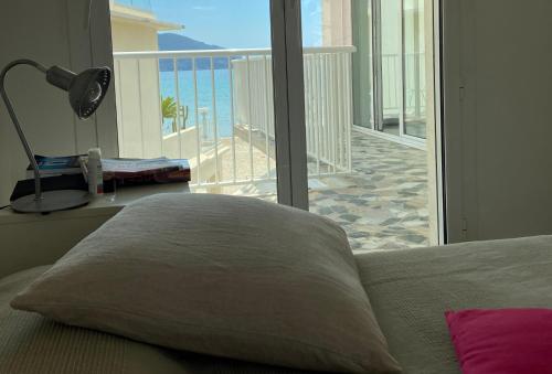 a bedroom with a bed and a view of the ocean at Les Pieds dans l'Ô - Appartement 50m2 Front de mer in Saint-Cyr-sur-Mer
