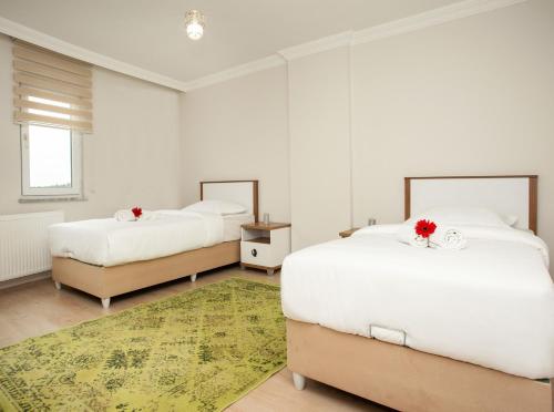 מיטה או מיטות בחדר ב-Al Jannah Residence