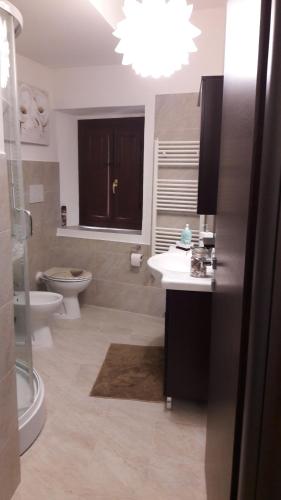 a bathroom with a toilet and a sink and a shower at Borgo Relax in Stroncone