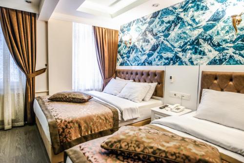 Ένα ή περισσότερα κρεβάτια σε δωμάτιο στο Lazz City Hotel