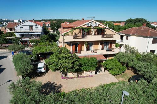 an aerial view of a house in a city at Apartments and Rooms Sinka in Biograd na Moru
