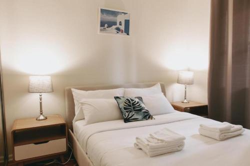 a bedroom with a bed with towels on it at Lotus Stay Manly - Apartment 29C in Sydney