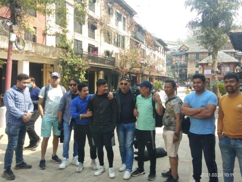 a group of men standing on a city street at Good Hotel in Bandīpur