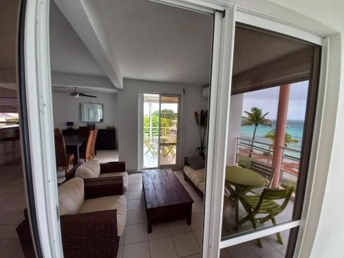 a living room with a view of the ocean at Rosa solarium 97 in Sainte-Anne